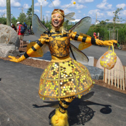 Ambient character event greeter interacting with guests during a live event performance