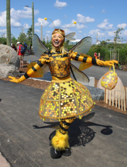 Ambient character event greeter interacting with guests during a live event performance