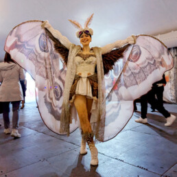 Ambient character event greeter interacting with guests during a live event performance