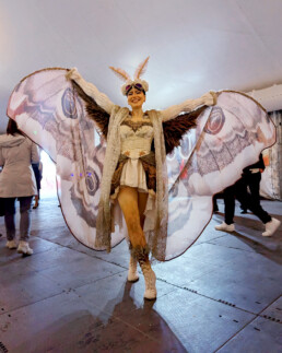 Ambient character event greeter interacting with guests during a live event performance
