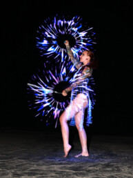 LED performer creating a dynamic light-based live performance with illuminated costume and props